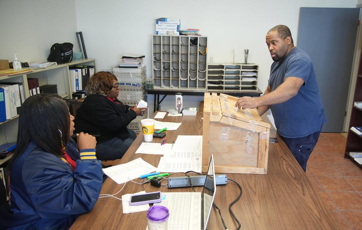 Union member Corey Troupe drops his vote into the Ballot box as executive board members Demetria Williams and Kay Holmes look on. A contract between CapMetro's bus operators and their current employer, MV Transportation, was ratified on Oct. 18, 2023. On Jan. 1, MV Transportation will be gone, and a new company called Keolis will take over.