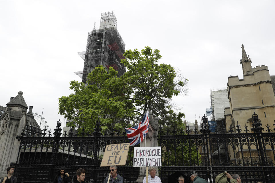 Brexit supporters holds placards as they protest outside the scaffolding-covered Big Ben at the Houses of Parliament in London, Tuesday, June 18, 2019. All six contenders to replace British Prime Minister Theresa May as leader of the ruling Conservative party vow they will succeed where May failed and lead Britain out of the European Union, though they differ about how they plan to break the country's Brexit deadlock. (AP Photo/Matt Dunham)