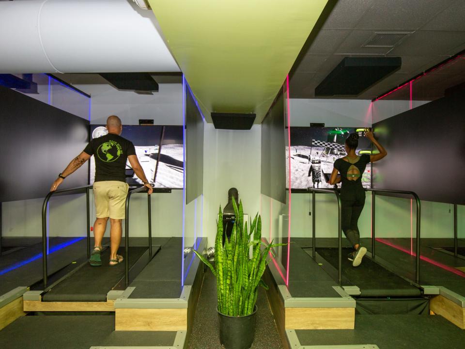 Two people running on the treadmill pod at Roam149.