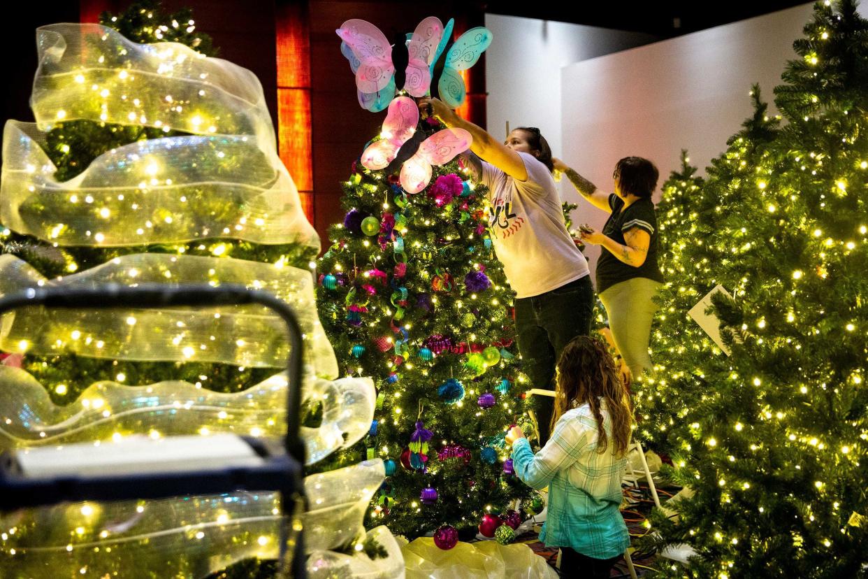 Danielle Haines, of Brooklyn, decorates a tree at the Festival of Trees & Lights in 2019. The event is a fundraiser for Blank Children's Hospital.