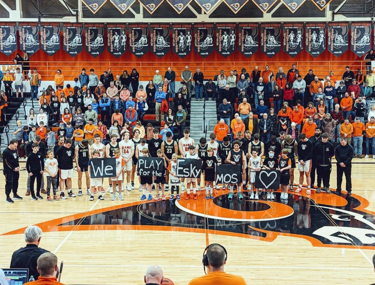 The Harbor Springs and St. Ignace high school basketball teams hold a moment of silence before their game on Monday, Jan. 30, to show support for Escanaba.