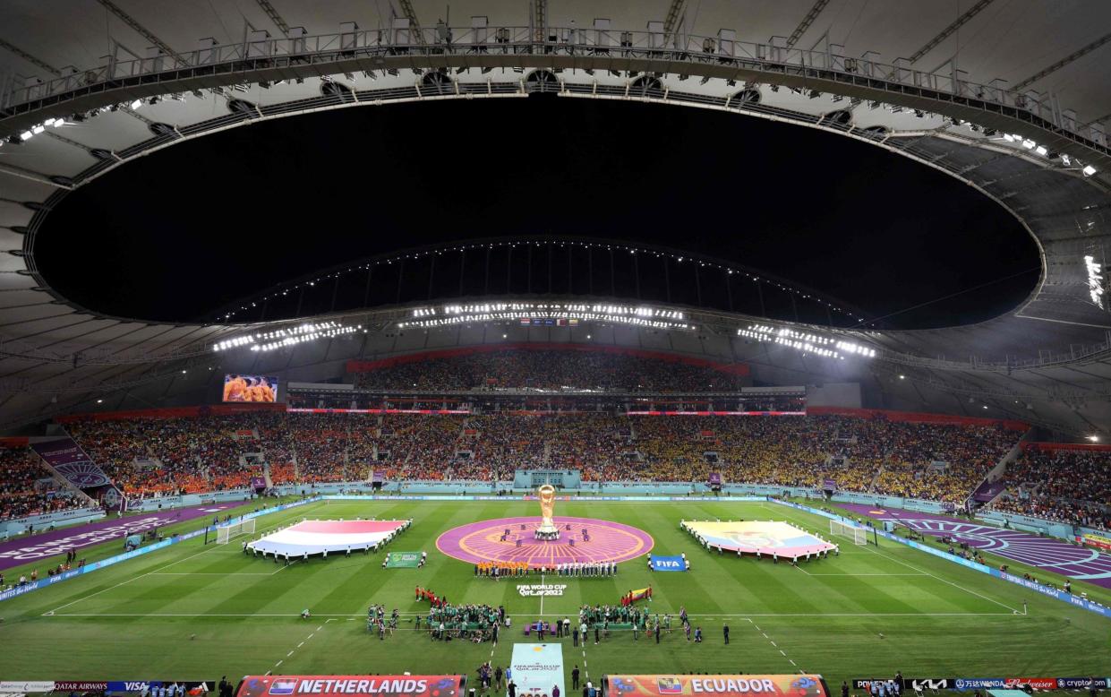 A general view shows the Netherlands and Ecuador flags displayed on the pitch as players listen to their national anthems ahead of the Qatar 2022 World Cup Group A football match between the Netherlands and Ecuador at the Khalifa International Stadium in Doha on November 25, 2022 - Qatar planning bid for Olympics - and would have to switch it from summer - Adrian Dennis/Getty Images