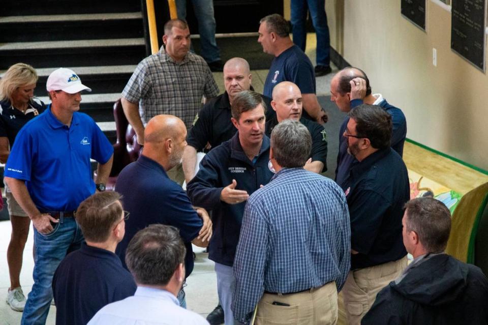 Gov. Andy Beshear speaks officials from Perry County and the City of Hazard before a press conference concerning the flooding in Eastern Kentucky at the Perry County Courthouse in Hazard, Ky., Sunday, July 31, 2022.