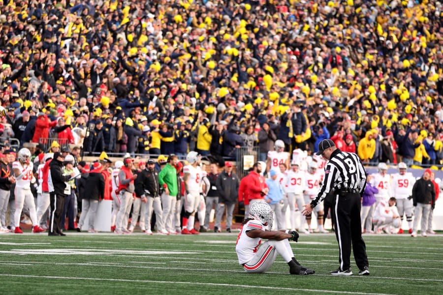 ANN ARBOR, MICHIGAN – NOVEMBER 25: Marvin Harrison Jr. #18 of the Ohio State Buckeyes reacts after Rod Moore #9 of the Michigan Wolverines intercepted a pass late in the second quarter during the game at Michigan Stadium on November 25, 2023 in Ann Arbor, Michigan. (Photo by Gregory Shamus/Getty Images)