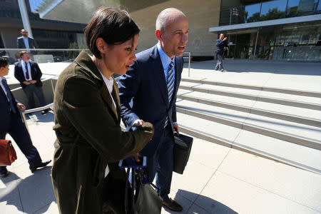 Michael Avenatti, lawyer for adult-film actress Stephanie Clifford, also known as Stormy Daniels, shakes hands with journalist Alex Wagner outside the U.S. District Court for the Central District of California after a hearing regarding Clifford's case against Donald J. Trump in Los Angeles, California, April 20, 2018. REUTERS/Mike Blake