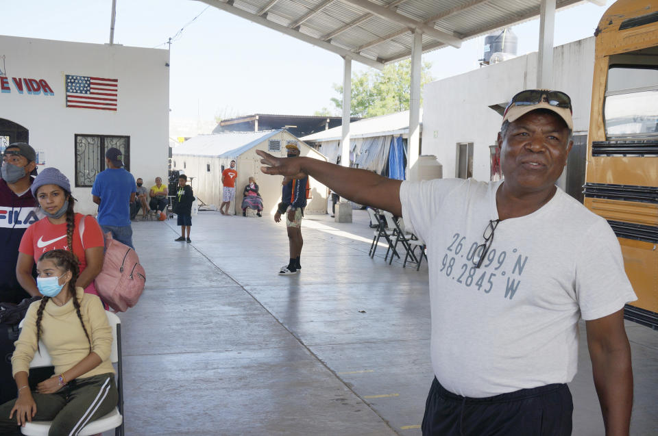 The Rev. Hector Silva points out some of the facilities in Senda de Vida 1, one of the migrant shelters he runs in Reynosa, Mexico, just across the Rio Grande River from the United States. More than 1,200 migrants, including some 200 recently arrived Russians, wait there for a chance to be admitted to the United States to seek asylum. (AP Photo/Giovanna Dell'Orto)