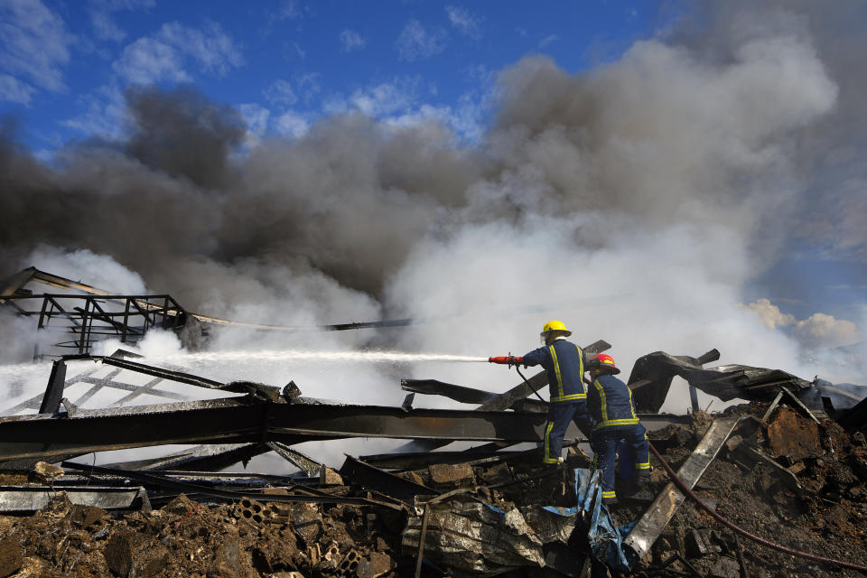 Firefighters extinguish a fire at a destroyed warehouse that was targeted on Monday by Israeli airstrikes, at an industrial district in the southern coastal town of Ghazieh, Lebanon, Tuesday, Feb. 20, 2024. Israeli warplanes carried out at least two strikes near the southern port city of Sidon in one of the largest attacks near a major city, wounding a dozen of people, Lebanese state media said. (AP Photo/Bilal Hussein)