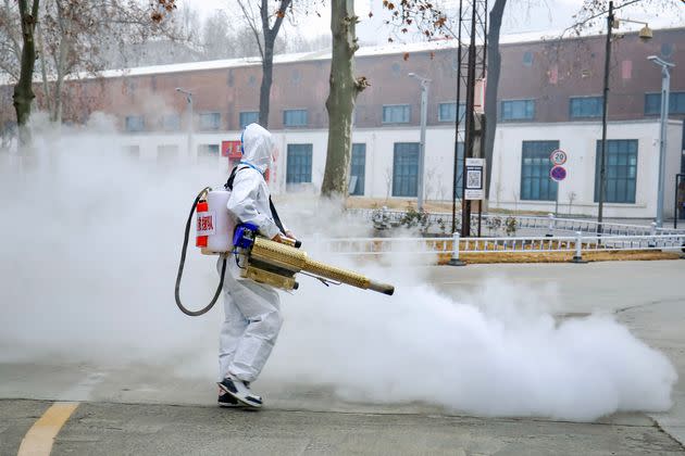 A volunteer wearing personal protective equipment sprays disinfectant at a park on Jan. 11 in Zhengzhou, China. (Photo: VCG via Getty Images)