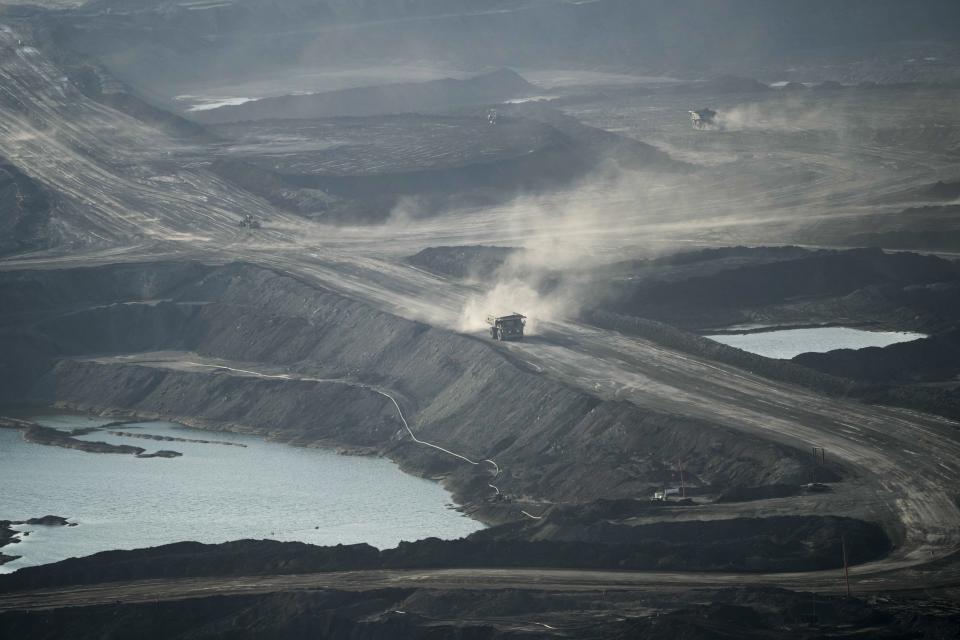 A truck carries oil sand at Suncor's facility near Fort McMurray, Canada, on Friday, Sep. 1, 2023. Extraction from this area, referred to as the "oil sands," uses huge amounts of energy, making Canada's oil — most of which is extracted here — some of the world's dirtiest. (AP Photo/Victor R. Caivano)