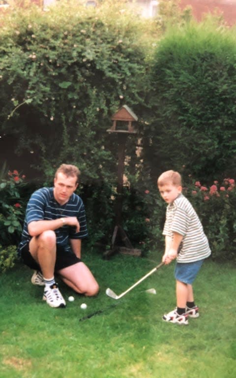 Ash Turner playing golf in his family's back garden with his father Simon - Credit: Family photograph