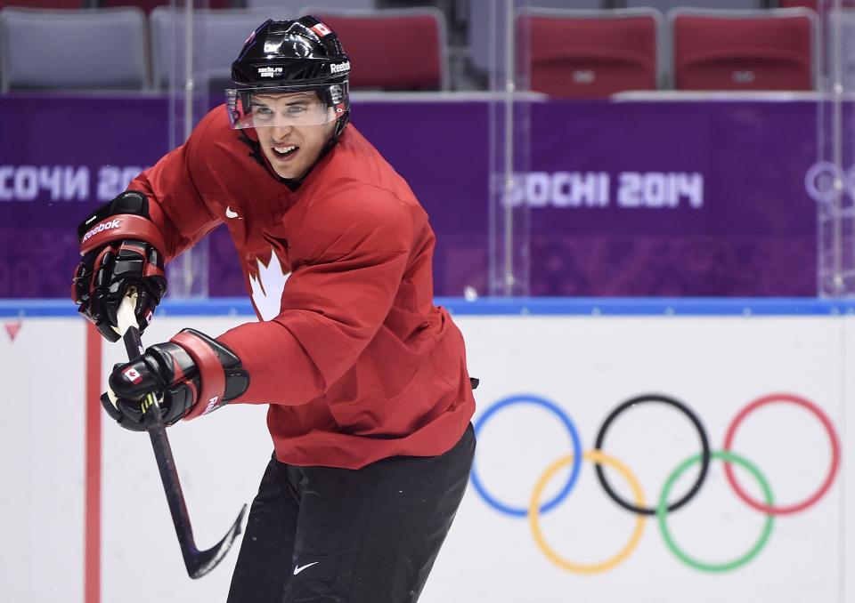 Team Canada captain Sidney Crosby shoots the puck as he takes part in a practice session during the 2014 Sochi Winter Olympics in Sochi, Russia, on Monday, Feb. 10, 2014. (AP Photo/The Canadian Press, Nathan Denette)