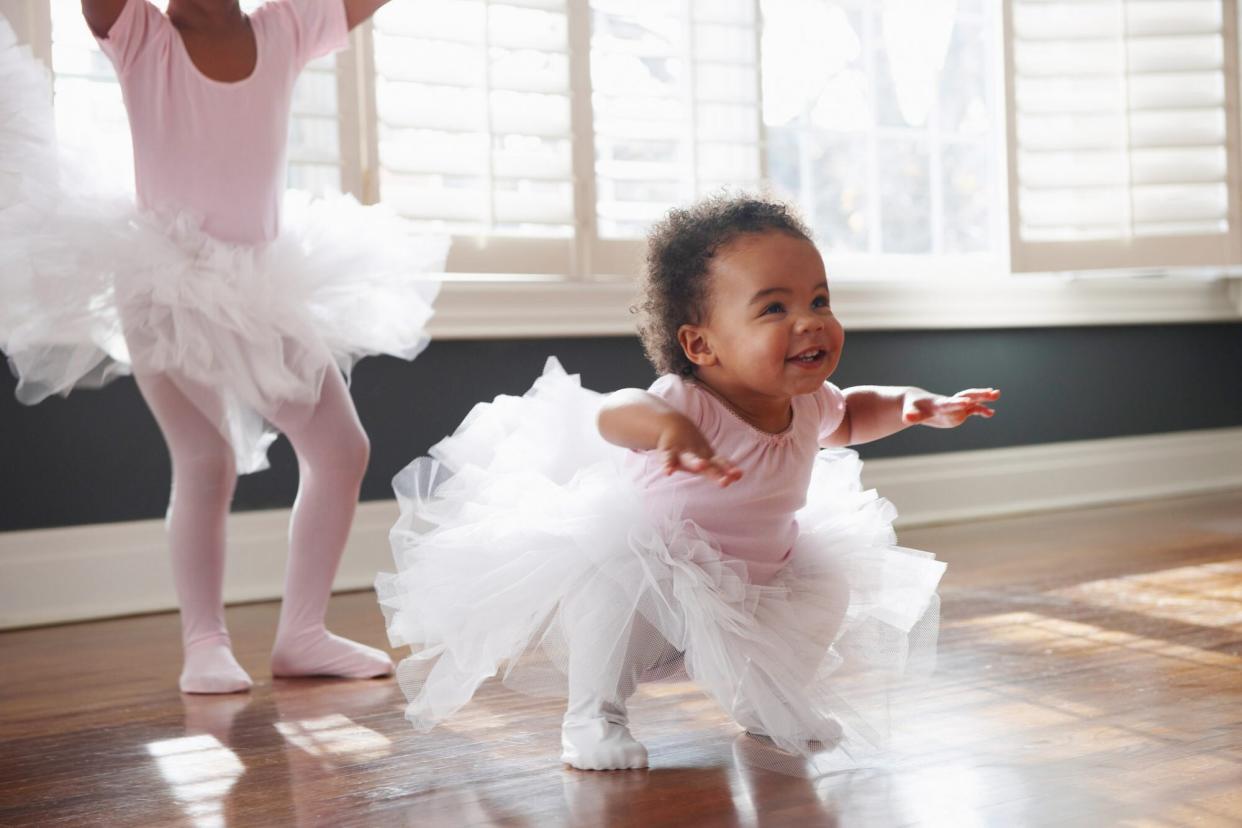 An image of two little girls dancing in tutus.