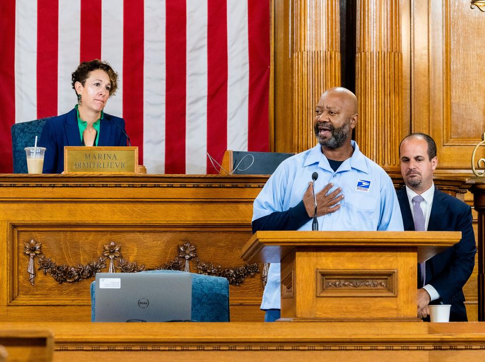 Michael "Mailman Mike" Boothe makes remarks after being honored by Alderman Jonathan Brostoff (right) in the Common Council chambers on Tuesday, Sept. 19, 2023.