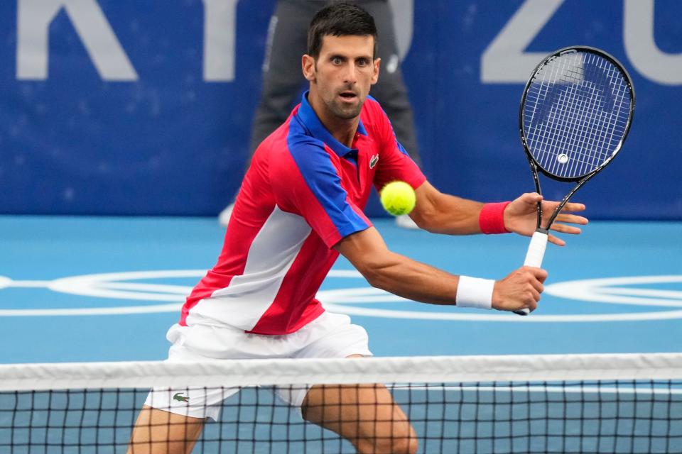 Novak Djokovic returns a shot against Alexander Zverev  in the men's singles semifinals during the Tokyo Olympics at Ariake Tennis Park.