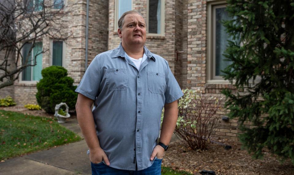 David Markiewicz, 45, of Shelby Township, stands in front of his home in Shelby Township on Saturday, Nov. 12, 2022. 