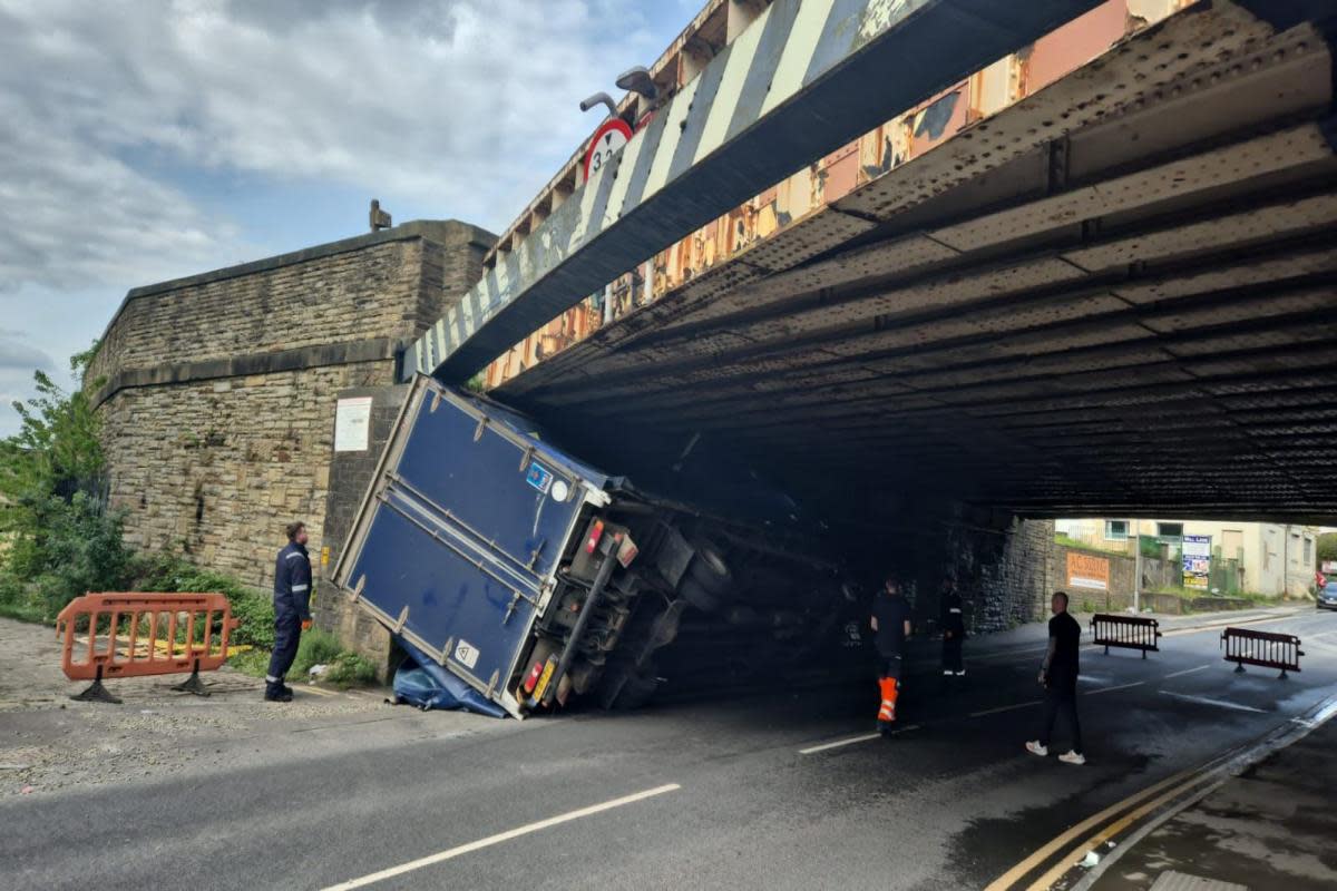 The truck on its side under the bridge <i>(Image: Newsquest)</i>