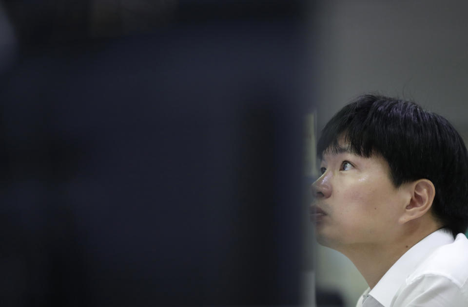 A currency trader watches the computer monitors at the foreign exchange dealing room in Seoul, South Korea, Tuesday, Oct. 2, 2018. Asian shares fell on Tuesday as relief that the United States had brokered a trade deal with Canada gave way to concerns that negotiations with China were at a standstill. (AP Photo/Lee Jin-man)