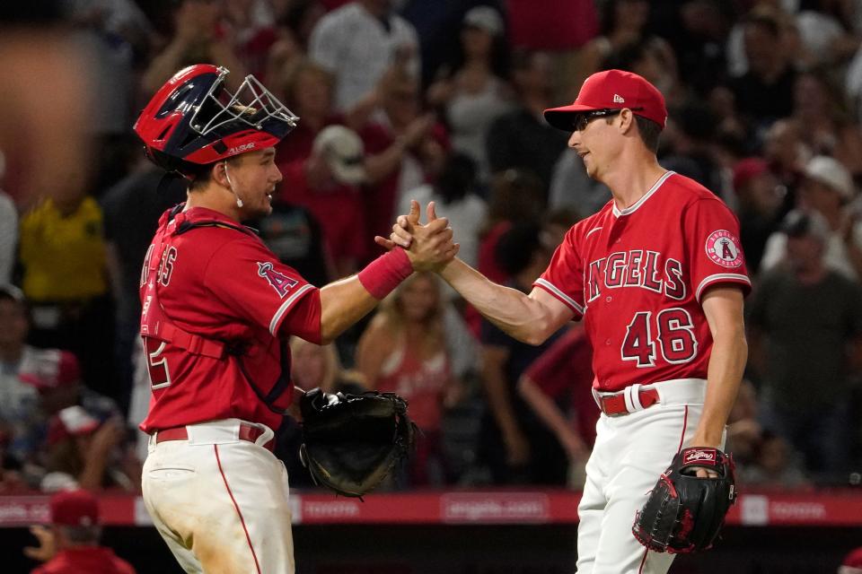 Los Angeles Angels catcher Matt Thaiss, left, and relief pitcher Jimmy Herget congratulate each other after the Angels defeated the New York Yankees 4-3 in a baseball game Monday, Aug. 29, 2022, in Anaheim, Calif. (AP Photo/Mark J. Terrill)