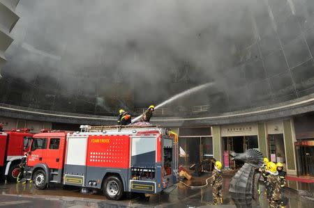 Firefighters try to put out a fire at HNA Hotel in Nanchang, Jiangxi province, February 25, 2017. REUTERS/Stringer