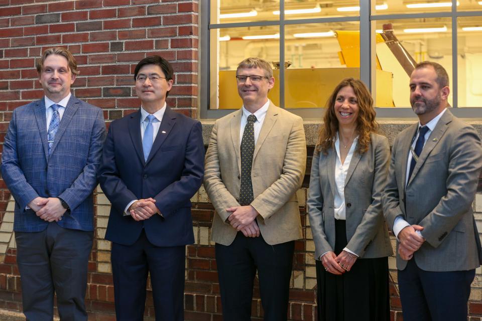 Adam Baxmeyer, Purdue University's airport manager, Mung Chiang, president of Purdue University, Troy Hege, vice president of innovation and technology at Purdue University's Research Foundation, Keren Ronan, director of alliances and business development at Ericsson, and Robert Ulibarri, vice president and general manager of Saab, pose for a photo after Purdue University announced its new partnership with Ericsson and Saab to bring a private 5G network to Purdue's airport, on Monday, March 20, 2023, in West Lafayette, Ind.