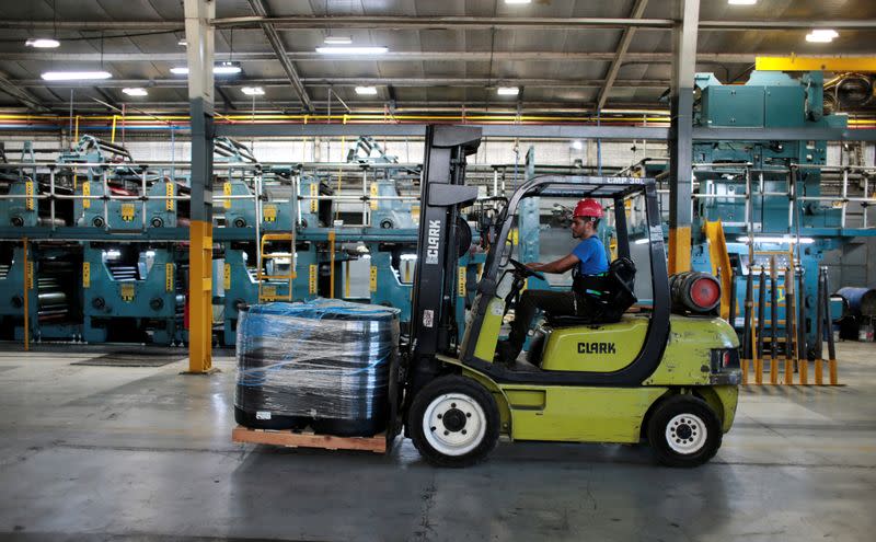 A fork lift truck driver moves boxes in the La Prensa newspaper printing plant in Managua