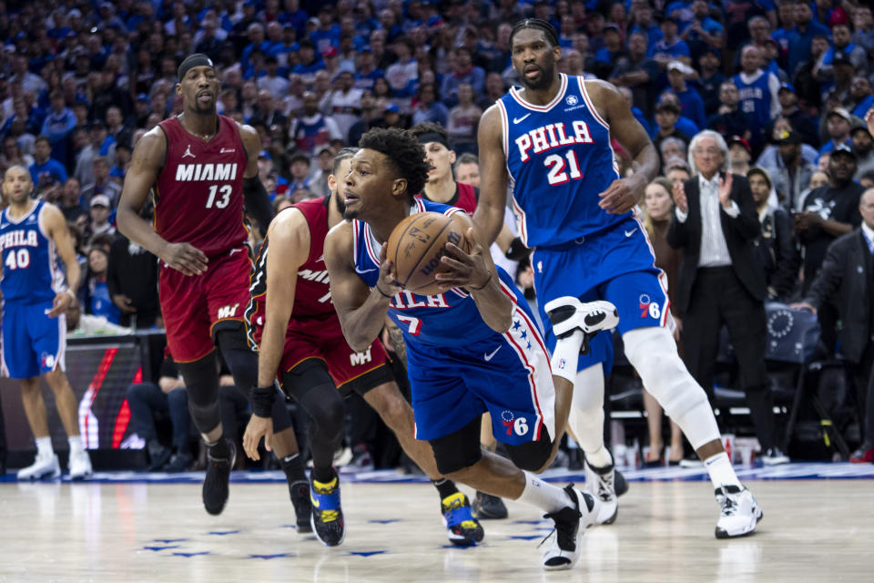 Philadelphia 76ers' Kyle Lowry, center, looks to pass the ball while losing his balance during the second half of an NBA basketball play-in tournament game against the Miami Heat, Wednesday, April 17, 2024, in Philadelphia. The 76ers won 105-104.(AP Photo/Chris Szagola)