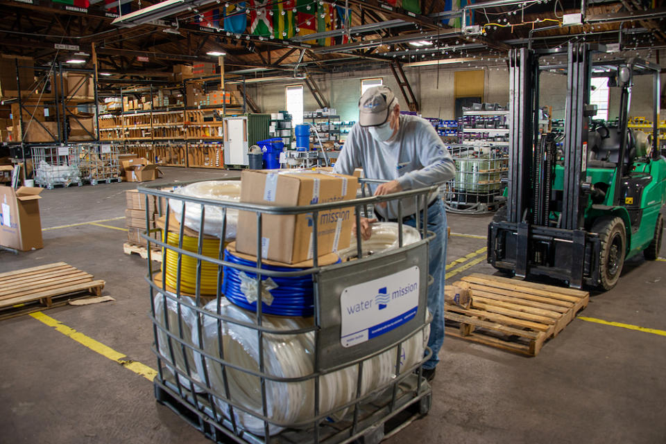 A man packs up a plumbing supplies shipment leaving Water Mission's Charleston, S.C., headquarters. (Water Mission)