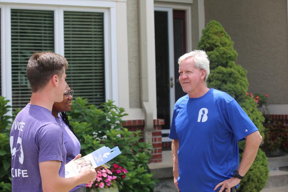 Volunteers with Susan B. Anthony Pro-Life America discuss the Aug. 2 anti-abortion constitutional amendment with Mike Hogeland of Olathe.