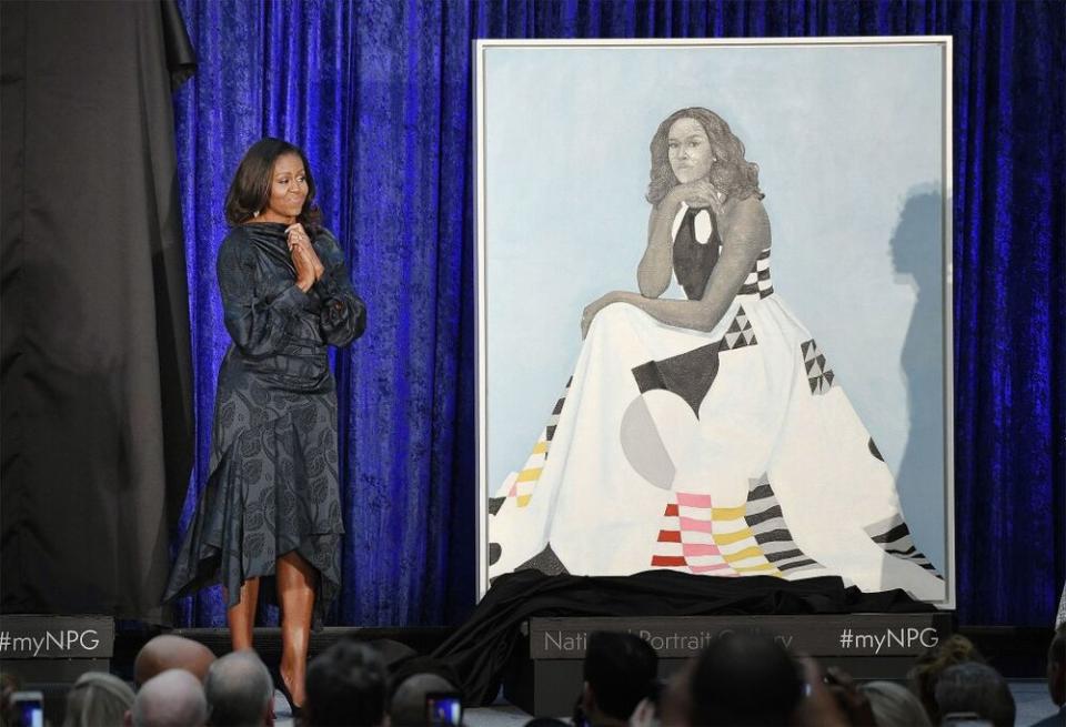 Former first lady Michelle Obama stands next to her Smithsonian portrait, painted by Amy Sherald. | Olivier Douliery/ABACA USA/INSTARimages.com