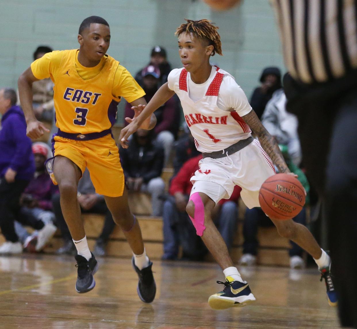 Franklin guard Shawn Goins pushes the ball upcoast past East guard Kesean Leonard during their Section V matchup Friday, Jan. 5, 2024 at East High School.