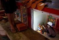 An employee paints a ready-made Chinese traditional temple at the Chuanso factory that manufactures religious objects in Pingtung, Taiwan July 5, 2016. REUTERS/Tyrone Siu