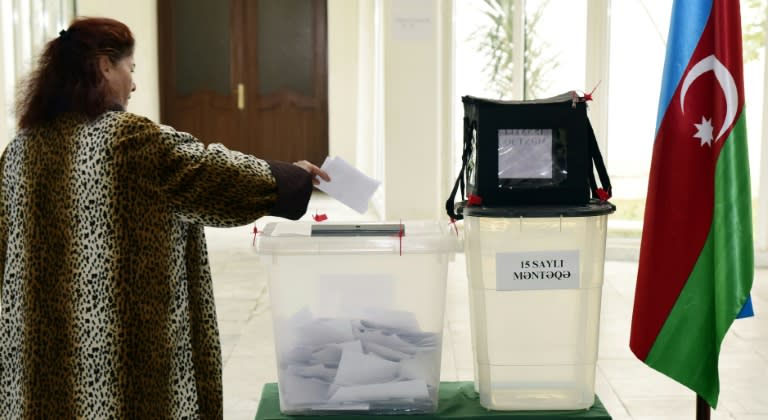 An Azeri woman casts her ballot at a polling station in the capital Baku on November 1, 2015