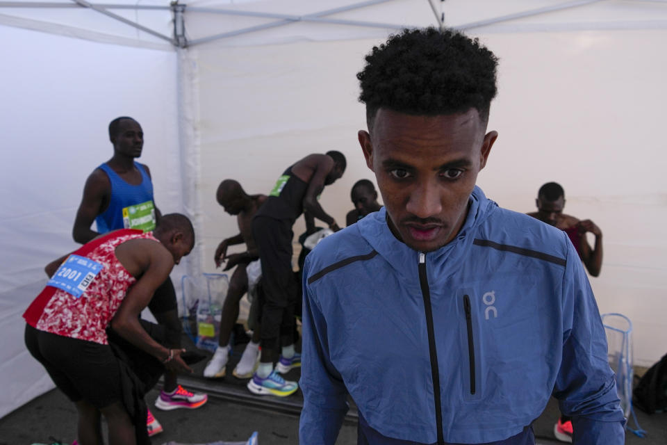 Tachlowini Gabriyesos, Eritrean born long distance runner prepares for the half marathon race in Belgrade, Serbia, Sunday, April 23, 2023. Gabriyesos fled his native Eritrea to Israel when he was just 12 years old. Gabriyesos, who will be 25 in July, ran a half-marathon race on Sunday at the Belgrade Marathon as part of a United Nations refugee agency team at the event. (AP Photo/Darko Vojinovic)