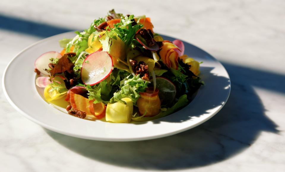 The rooftop restaurant's menu also includes shaved vegetable with baby greens, pecans and cider vinaigrette.