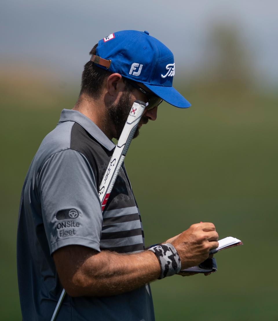 Professional golfer Tom Whitney marks down his score as he competes during the TPC Colorado Championship at Heron Lakes in Berthoud on July 9, 2021.