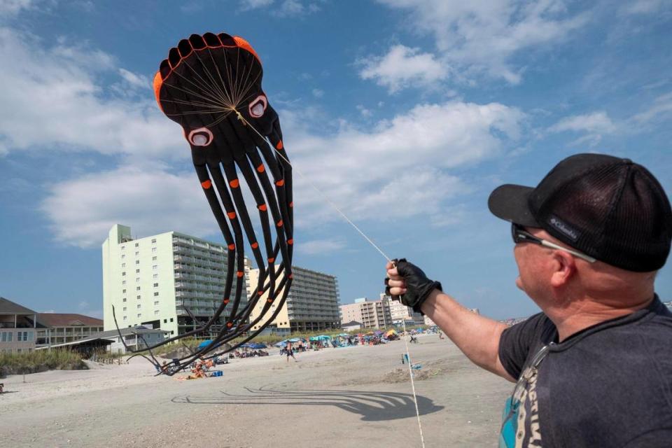 Dale Dove, of Rock Hill, South Carolina, launches his 50 foot long octopus kit in North Myrtle Beach, S.C. Kites, like his giant octopus are interactive and kids often play in the tentacles. Dove, who grew up in the area, has more than 80 kites and frequently flies them when he comes to visit his mother in North Myrtle Beach, S.C. July 20, 2023.