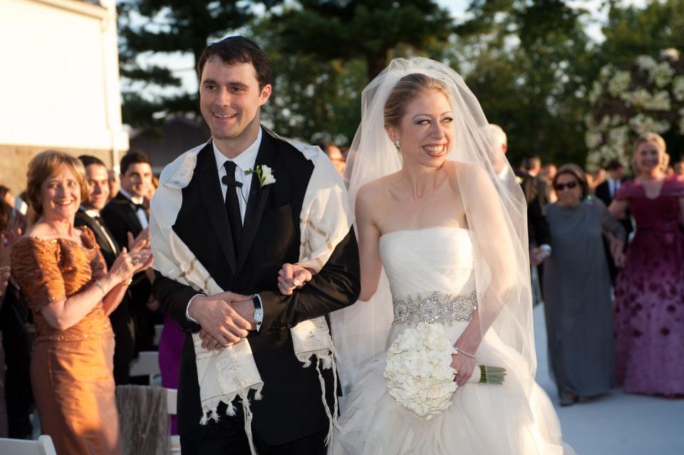 <p>America's former First Daughter, Chelsea Clinton, looks as happy as can be as she walks down the aisle with her husband, Marc Mezvinsky, following a ceremony in Rhinebeck, New York. </p>