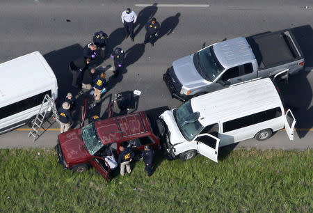 Law enforcement personnel investigate the scene where the Texas bombing suspect blew himself up on the side of a highway north of Austin in Round Rock, Texas, U.S., March 21, 2018. REUTERS/Loren Elliott