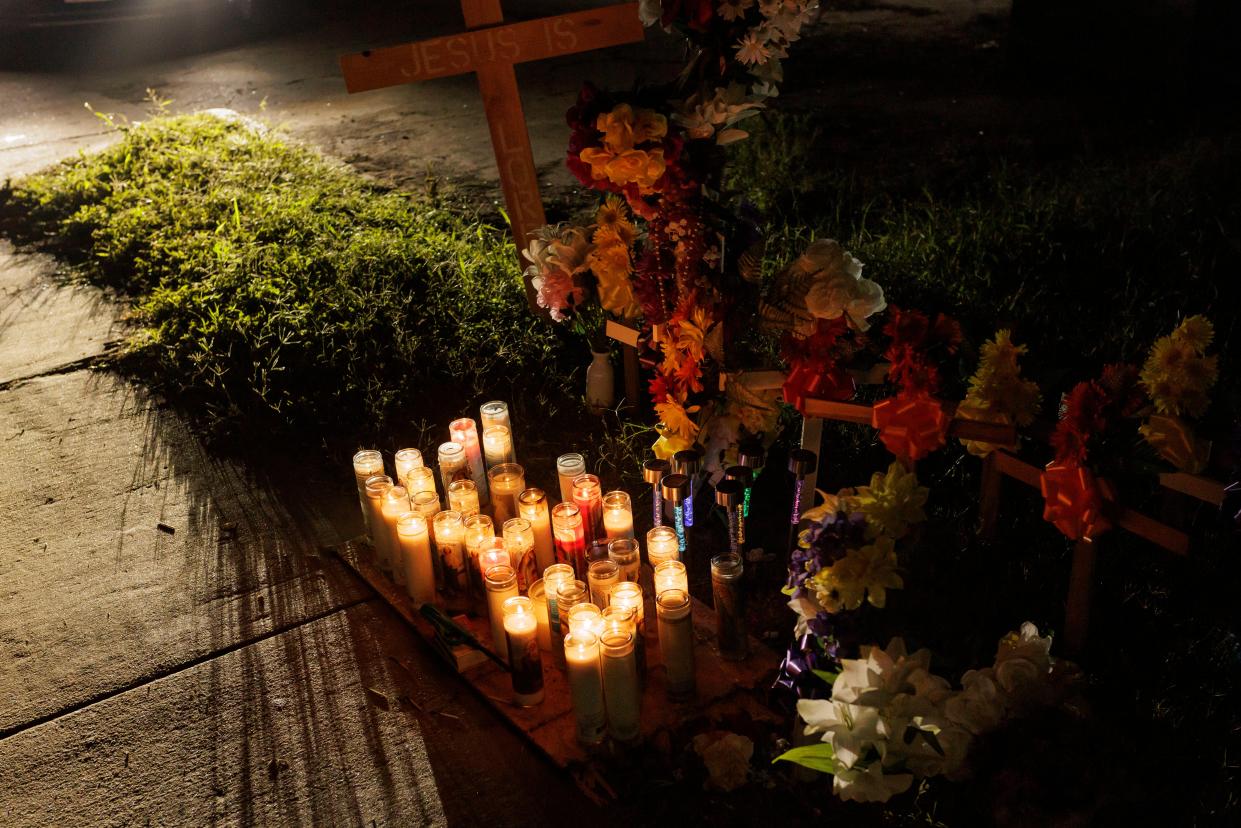 Votive candles, flowers and crosses setup at a memorial for eight migrants that were run over and killed today waiting at a bus stop on 7 May 2023 in Brownsville, Texas (Getty Images)