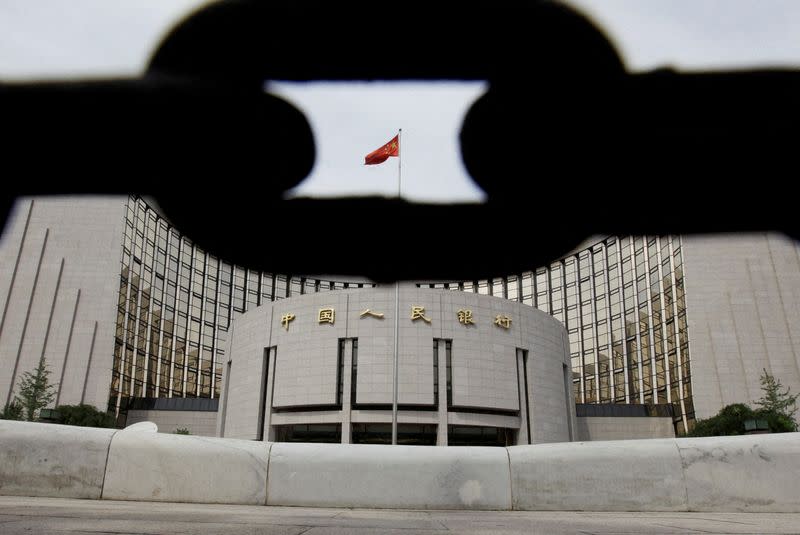 FILE PHOTO: The headquarters of the People's Bank of China, the central bank, is pictured behind an iron chain in Beijing