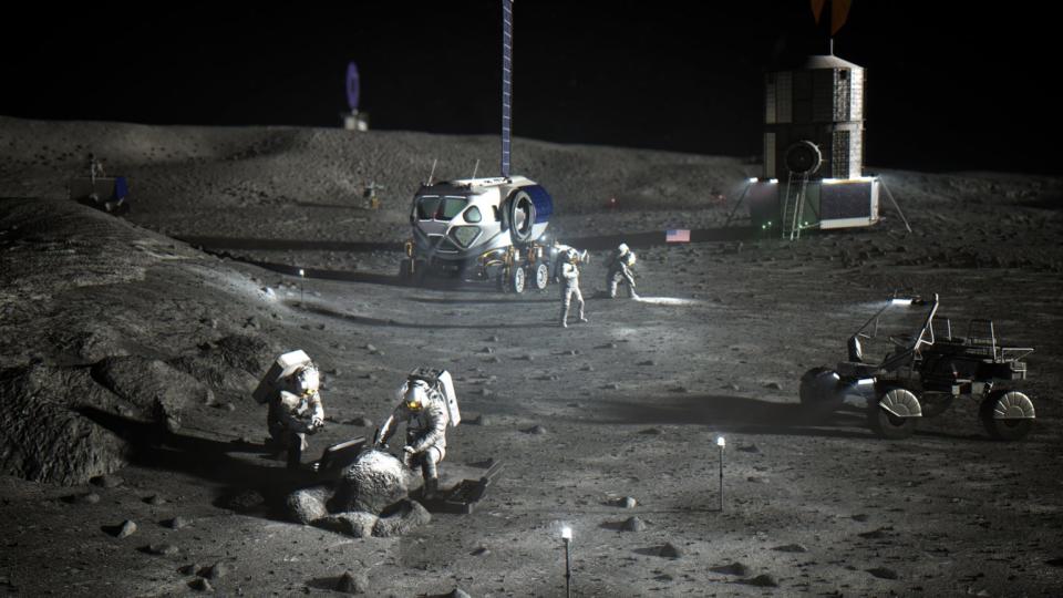 astronauts in white space suits working on the grey, dusty surface of the moon