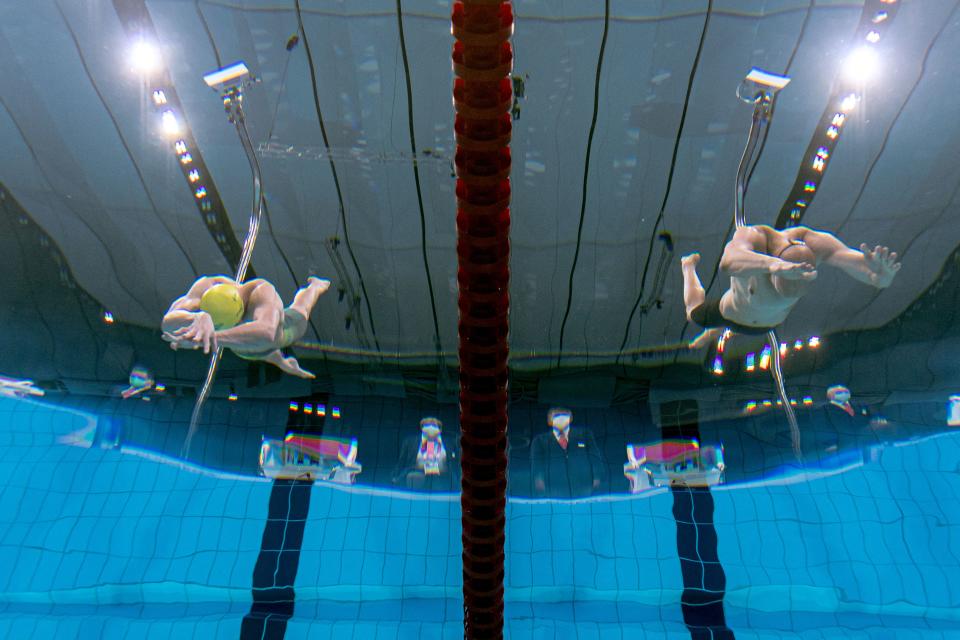 <p>An underwater view shows Finland's Matti Mattsson (R) and Australia's Izaac Stubblety-Cook diving to start a semi-final of the men's 200m breaststroke swimming event during the Tokyo 2020 Olympic Games at the Tokyo Aquatics Centre in Tokyo on July 28, 2021. (Photo by François-Xavier MARIT / AFP)</p> 