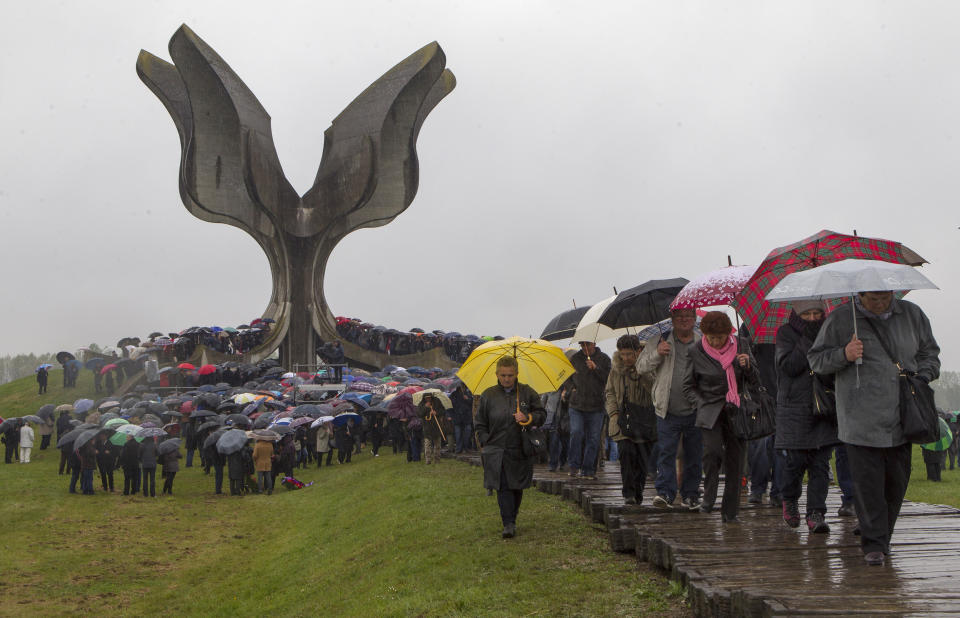 Hundreds gather at the memorial center to pay their respects for tens of thousands of people killed in death camps run by Croatia's pro-Nazi puppet state in WWII, in Jasenovac, Croatia, Friday, April 12, 2019. Croatia's Jewish, Serb, anti-fascist and Roma groups have commemorated the victims of a World War II death camp, snubbing the official ceremonies for the fourth year in a row over what they say is government inaction to curb neo-Nazi sentiments in the European Union country. (AP Photo/Nikola Solic)