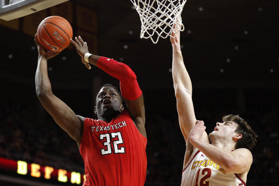 Texas Tech center Norense Odiase (32) drives to the basket over Iowa State forward Michael Jacobson during the first half of an NCAA college basketball game, Saturday, March 9, 2019, in Ames, Iowa. (AP Photo/Charlie Neibergall)