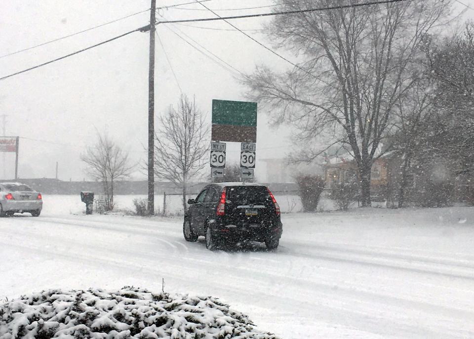An SUV pulls onto a snow-covered Mont Alto Road at Lincoln Way East on Wednesday in Fayetteville, Pa. In preparation for the winter storm that started shortly before 10 a.m., some school districts delayed their opening.