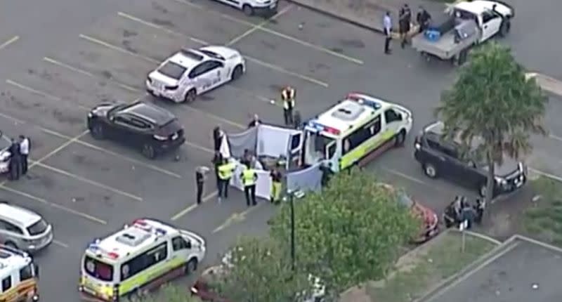 Emergency crews attend to the child in the car park of the service station. Source: 7News