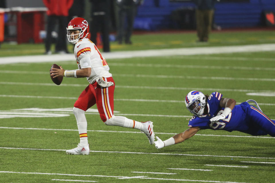 Kansas City Chiefs quarterback Patrick Mahomes, left, outruns Buffalo Bills' Darryl Johnson during the second half of an NFL football game, Monday, Oct. 19, 2020, in Orchard Park, N.Y. (AP Photo/Jeffrey T. Barnes)