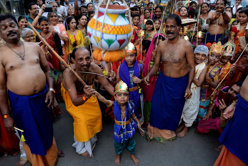 <p>A boy helps dressed as Hindu deity Krishna is helped to break a curd pot during ‘Krishna Janmashtami’ festival celebrations in Chennai on September 2, 2018. – ‘Krishna Janmashtami’ also known as Gokulashtami is an annual Hindu festival that celebrates the birth of Krishna. (Photo by ARUN SANKAR/AFP/Getty Images) </p>