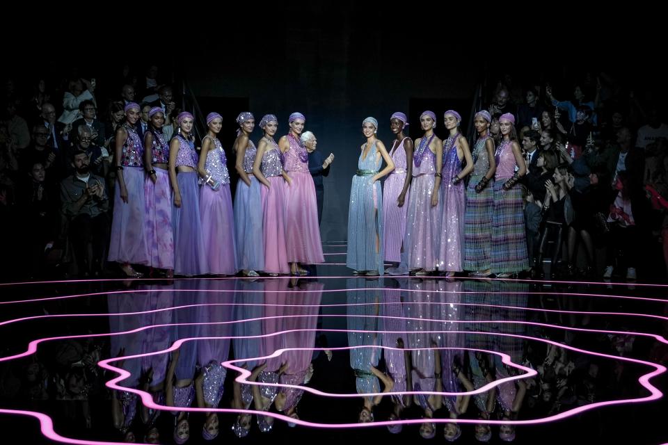 Giorgio Armani, centre, accepts applause as he stands with models after the conclusion of the Emporio Armani women's Spring Summer 2024 collection presented in Milan, Italy, Thursday, Sept. 21, 2023. (AP Photo/Luca Bruno)