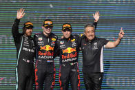 From left to right, Mercedes driver Lewis Hamilton, of Britain, Red Bull driver Max Verstappen, of the Netherlands, Red Bull driver Sergio Perez, of Mexico, and Honda's F1 managing director Masashi Yamamoto celebrate after the Formula One U.S. Grand Prix auto race at Circuit of the Americas, Sunday, Oct. 24, 2021, in Austin, Texas. (AP Photo/Nick Didlick)